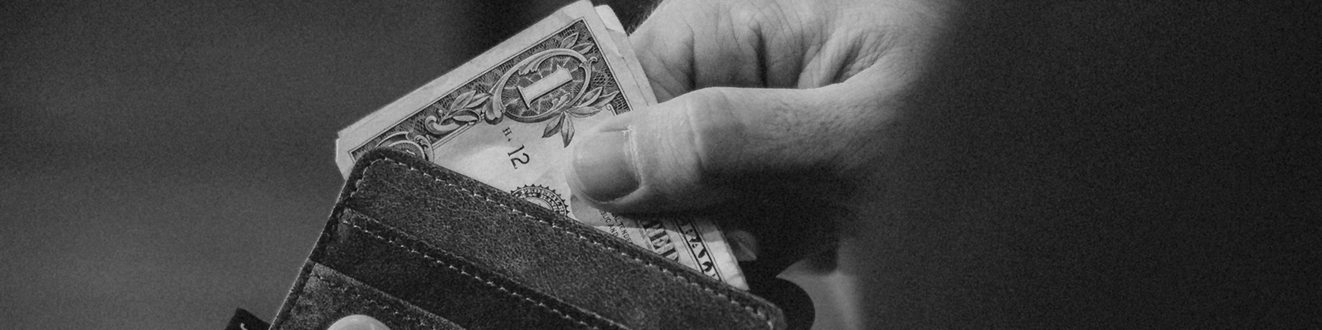 man taking cash out of wallet